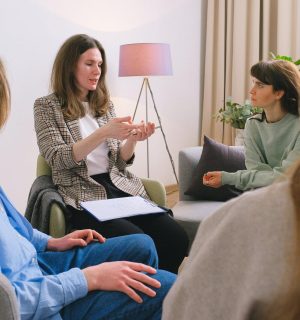Mental female specialist speaking to group of clients